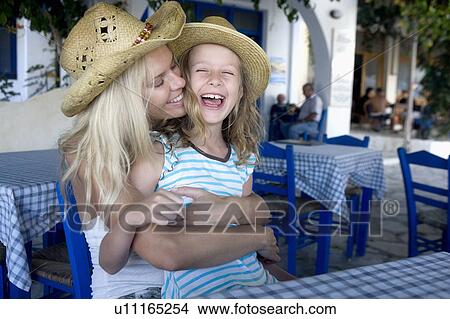 Woman with young girl at an outdoor restaurant smiling. View Large Photo Image Picture - Woman with young girl at an outdoor restaurant smiling.. Fotosearch