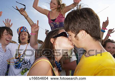 Picture - Couple kissing in front of crowd. Fotosearch