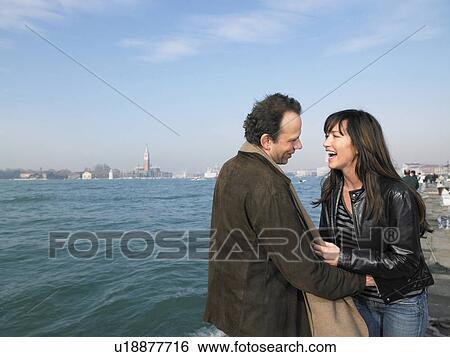 Stock Photograph - Couple laughing. Venice, Italy.. Fotosearch