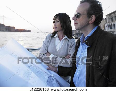 Couple with architect's blueprint. Venice, Italy. View Large Photo Image Stock Photograph - Couple with architect's blueprint. Venice, Italy.. Fotosearch