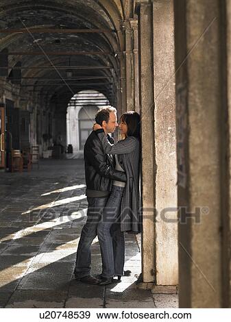 Italy, Venice, couple embracing in colonnade View Large Photo Image Stock Photo - Italy, Venice, couple embracing in colonnade. Fotosearch
