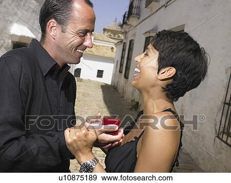 Stock Photo - Man proposing to woman.. Fotosearch