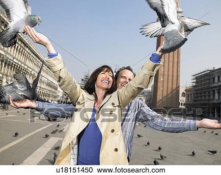 Portrait of couple with pigeons. St Mark's Square, Venice, Italy. View Large Photo Image Stock Image - Portrait of couple with pigeons. St Mark's Square, Venice, Italy.. Fotosearch