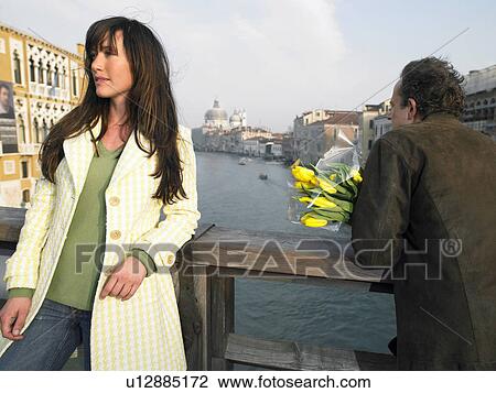 Woman and man with flowers on Academia Bridge overlooking Grand Canal. Venice, Italy. View Large Photo Image Stock Image - Woman and man with flowers on Academia Bridge overlooking Grand Canal. Venice, Italy.. Fotosearch