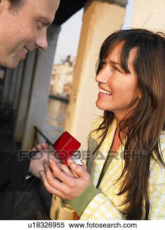 Woman receiving engagement ring from man. Venice, Italy. View Large Photo Image Stock Photography - Woman receiving engagement ring from man. Venice, Italy.. Fotosearch