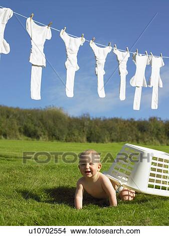 Baby crawling with washing basket. View Large Photo Image Picture - Baby crawling with washing basket.. Fotosearch