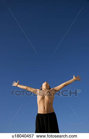 Stock Photo - Boy with arms outstretched. Fotosearch