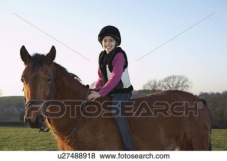 Girl riding her pony View Large Photo Image Stock Photo - Girl riding her pony. Fotosearch