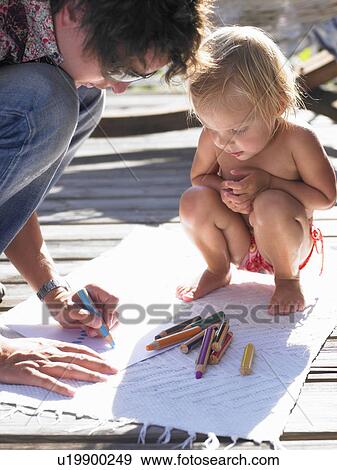 Little girl and man drawing a picture View Large Photo Image Stock Photo - Little girl and man drawing a picture. Fotosearch