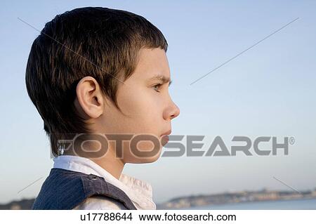Picture - Young boy looking out to sea. Fotosearch