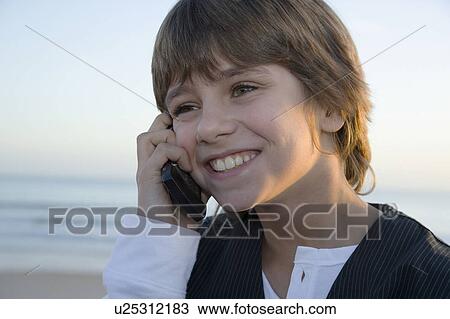 Stock Image - Young boy on cell phone. Fotosearch