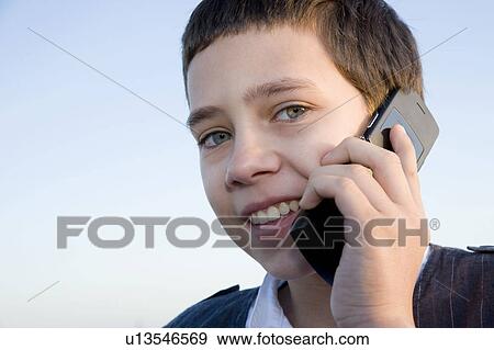 Young boy on cell phone View Large Photo Image Stock Photo - Young boy on cell phone. Fotosearch