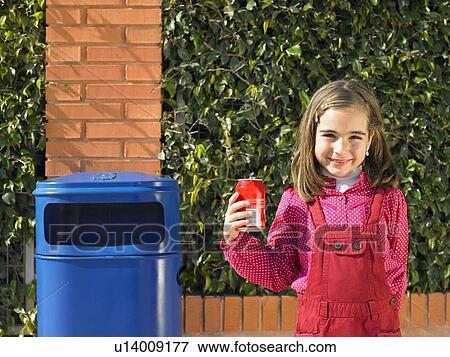 Young girl (5-7) posing with can next to public bin, Alicante, Spain, View Large Photo Image Stock Photo - Young girl (5-7) posing with can next to public bin, Alicante, Spain,. Fotosearch