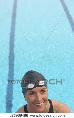 Female swimmer by pool, smiling View Large Photo Image Stock Photograph - Female swimmer by pool, smiling. Fotosearch
