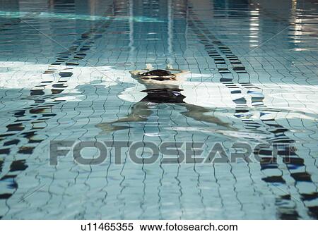 Mature man swimming underwater in swimming pool View Large Photo Image Stock Photography - Mature man swimming underwater in swimming pool. Fotosearch