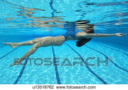 Woman swimming in pool, underwater view View Large Photo Image Stock Image - Woman swimming in pool, underwater view. Fotosearch