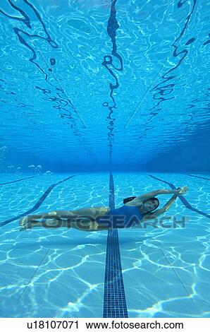 Woman swimming in pool, underwater view View Large Photo Image Stock Image - Woman swimming in pool, underwater view. Fotosearch