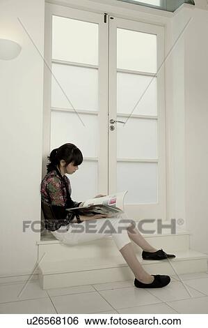 Portrait of a woman sitting on a step View Large Photo Image Stock Photograph - Portrait of a woman sitting on a step. Fotosearch