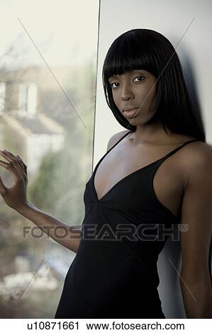 Woman next to a window View Large Photo Image Stock Image - Woman next to a window. Fotosearch