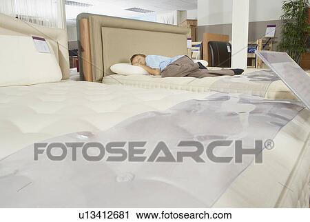Boy sleeping on bed in furniture store. View Large Photo Image Stock Image - Boy sleeping on bed in furniture store.. Fotosearch