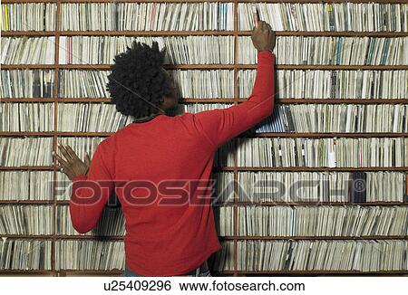 Man choosing compact disc from shelf in music shop, rear view View Large Photo Image Stock Photograph - Man choosing compact disc from shelf in music shop, rear view. Fotosearch