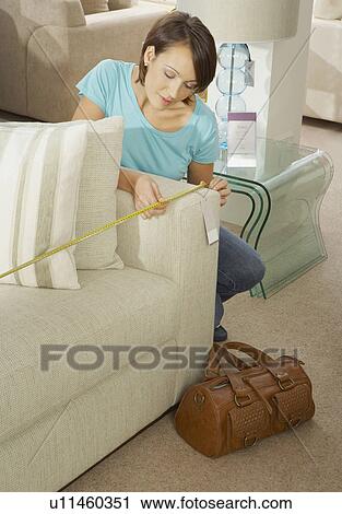 Woman measuring sofa in furniture store. View Large Photo Image Stock Image - Woman measuring sofa in furniture store.. Fotosearch