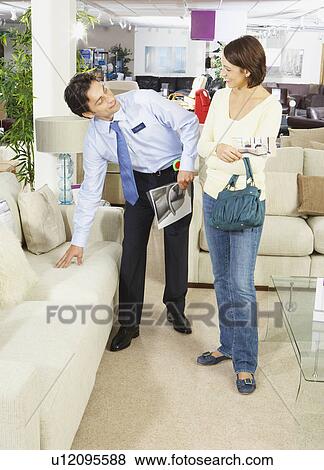 Woman talking to salesman in sofa shop. View Large Photo Image Stock Photo - Woman talking to salesman in sofa shop.. Fotosearch