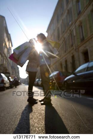Young couple standing in street, Defocused (sun flare) View Large Photo Image Stock Image - Young couple standing in street, Defocused (sun flare). Fotosearch