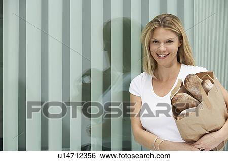 Young woman with bunch of fresh baguettes / loaves of bread. View Large Photo Image Stock Photograph - Young woman with bunch of fresh baguettes / loaves of bread.. Fotosearch