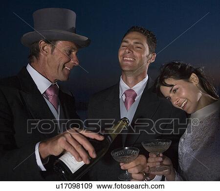 Bride and groom and mature father having champagne, smiling View Large Photo Image Stock Photo - Bride and groom and mature father having champagne, smiling. Fotosearch
