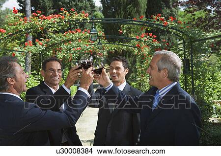 Four businessmen drinking wine in a garden View Large Photo Image Picture - Four businessmen drinking wine in a garden. Fotosearch