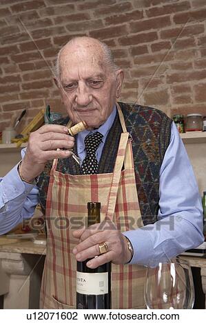 Senior man sniffing wine cork View Large Photo Image Stock Image - Senior man sniffing wine cork. Fotosearch