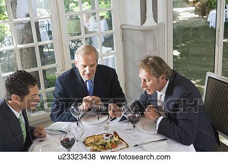 Three businessmen having lunch View Large Photo Image Stock Photo - Three businessmen having lunch. Fotosearch