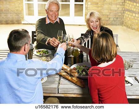 Two couples toasting with Champagne View Large Photo Image Stock Photograph - Two couples toasting with Champagne. Fotosearch