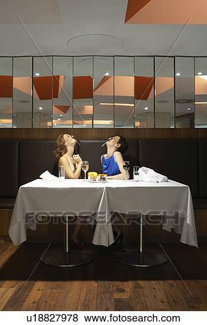 Two women in a restaurant with spoons on their noses View Large Photo Image Stock Photo - Two women in a restaurant with spoons on their noses. Fotosearch
