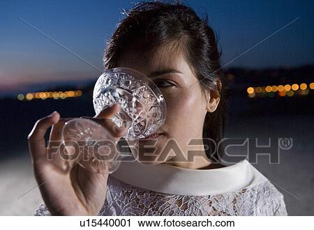 Young bride drinking champagne on beach, close-up, dusk View Large Photo Image Stock Image - Young bride drinking champagne on beach, close-up, dusk. Fotosearch