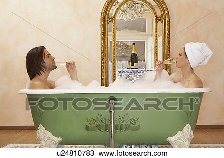 young couple sitting in bath drinking champagne, side view View Large Photo Image Stock Image - young couple sitting in bath drinking champagne, side view. Fotosearch