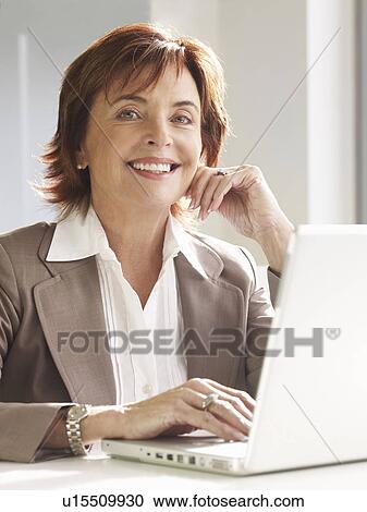 Stock Image - Senior woman at laptop. Fotosearch