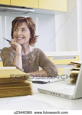 Senior woman running business from home View Large Photo Image Stock Photography - Senior woman running business from home. Fotosearch