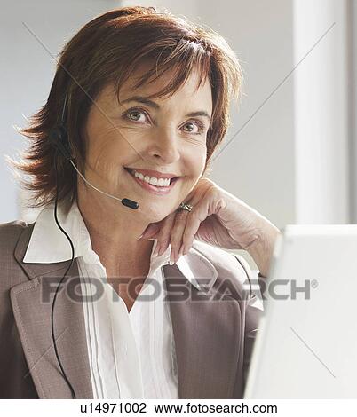 Senior woman with headset at laptop View Large Photo Image Stock Image - Senior woman with headset at laptop. Fotosearch