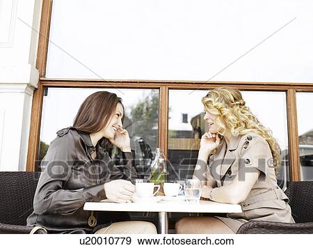 Stock Photo - Two women at an outdoor restaurant. Fotosearch