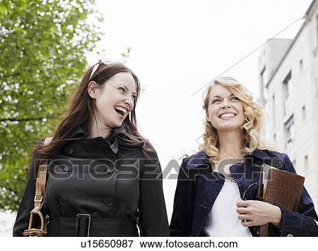 Stock Photo - Two women laughing outdoors. Fotosearch