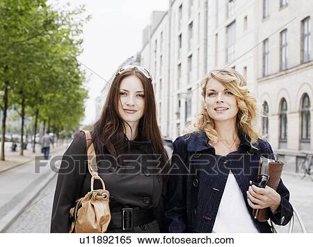 Two women walking outdoors View Large Photo Image Stock Photography - Two women walking outdoors. Fotosearch