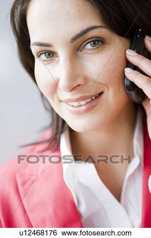 Stock Photograph - Woman phoning with her mobile phone. Fotosearch