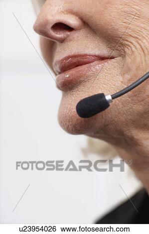 Woman smiling on headset View Large Photo Image Stock Photograph - Woman smiling on headset. Fotosearch