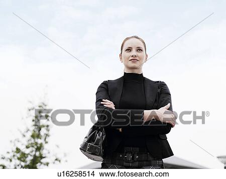 Picture - Woman standing outdoors . Fotosearch