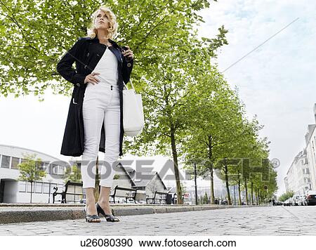 Woman standing outdoors View Large Photo Image Stock Image - Woman standing outdoors . Fotosearch