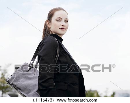 Woman standing outdoors View Large Photo Image Stock Photo - Woman standing outdoors . Fotosearch