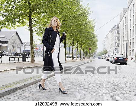 Woman standing outdoors View Large Photo Image Stock Photo - Woman standing outdoors . Fotosearch