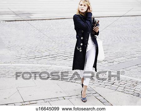 Woman standing outdoors View Large Photo Image Stock Photo - Woman standing outdoors . Fotosearch